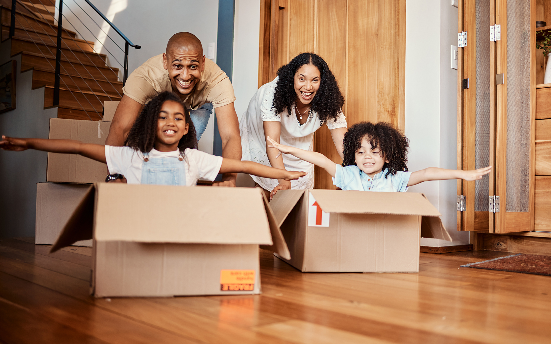 family moving into a new home and playing in boxes